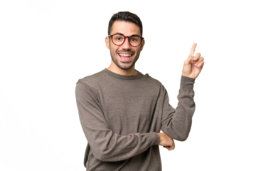 Young handsome caucasian man over isolated background happy and pointing up