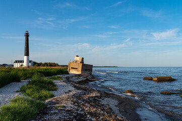 Sorve Lighthouse and border fortress. Located in Torgu Parish, Saaremaa over small bay. Summer day, bright blue sky over sand and gravel ground.