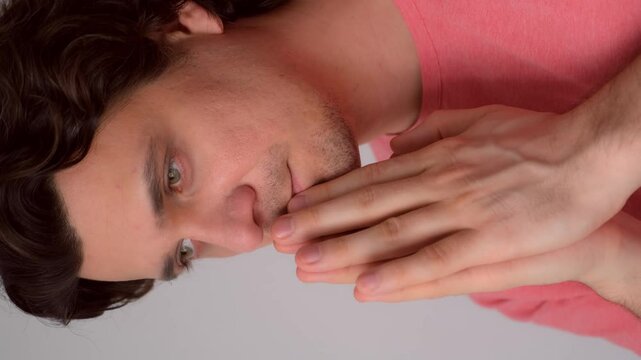 Portrait of pleading curly brunet middle aged man folded hands in prayer pose. Guy thinking dreaming worrying about future life feeling anxiety nervousness. Praying begging good things. Pray, prayer.
