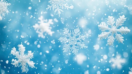Snowflakes gently falling from the sky against a serene blue background. Perfect for winter-themed projects and holiday designs.