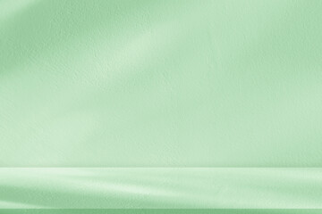 Background Green Studio Room with Nature light,Shadow on Podium Display for Cosmetic Product.Summer Backdrop with Shadow leaves on concrete wall,floor texture,Empty light green background platform