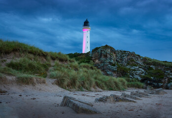 Stormy afternoon on the beach with a view of the lighthouse in the town of Elgin, Scotland.