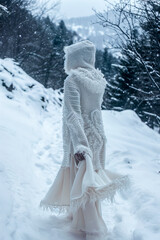 Woman in Hooded Sweater Walking Through Snowy Forest Path
