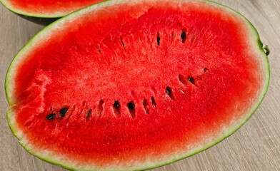 Close-up of cut ripe juicy red watermelon with seeds