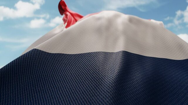 Wavy flag of France blowing in the wind in slow motion. Waving colorful French flag team symbol abstract vertical background. Blue sky with clouds. World countries flying flags concept
