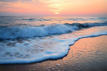 Naklejka premium The gentle waves lap at the sandy shore as the sun sets over the horizon, painting the sky in hues of pink and orange.