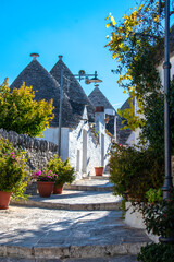 The unique and picturesque village of Alberobello featuring white washed trulli, structures unique...