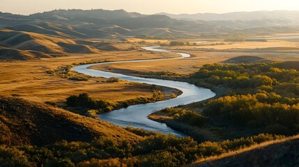 Fototapeta premium Elevated Viewpoint Overlooking Rolling Hills and Winding River Bathed in Golden Sunlight