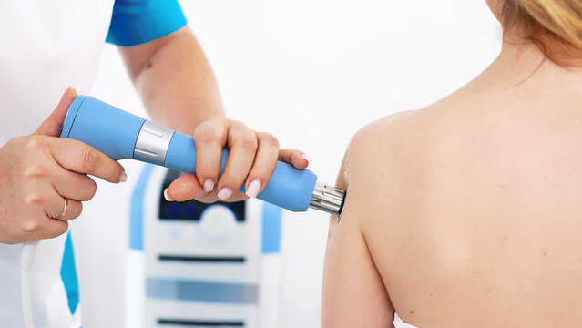 A physiotherapist provides shockwave therapy for body recovery. This advanced treatment reduces pain, promotes healing, and supports muscle and joint health for overall wellness.