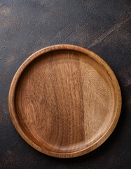 Handcrafted round wooden plate. Empty plate for food. Mock-up. Close-up. Top view