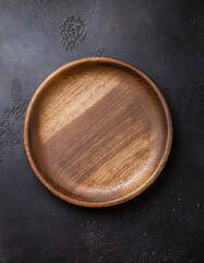 Handcrafted round wooden plate. Empty plate for food. Mock-up. Close-up. Top view