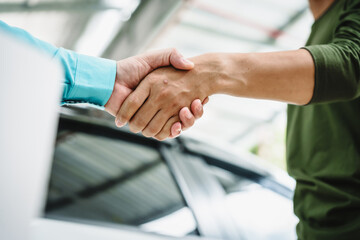 Car seller agent signs a car insurance agreement with salesman. The document outlines vehicle policy, premium, rental terms, with contract paper finalized using car insurance claim mobile phone.