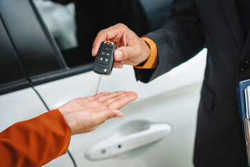 Car seller agent signs a car insurance agreement with salesman. The document outlines vehicle policy, premium, rental terms, with contract paper finalized using car insurance claim mobile phone.