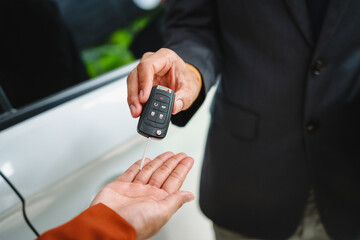 Car seller agent signs a car insurance agreement with salesman. The document outlines vehicle policy, premium, rental terms, with contract paper finalized using car insurance claim mobile phone.
