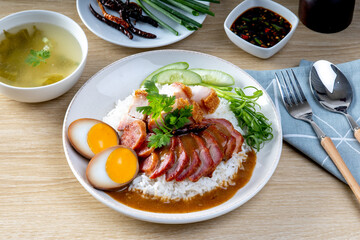 Barbecued red pork in sauce with rice on a white plate, Chinese style roasted pork.