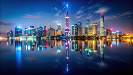 Obraz premium Shanghai skyline at night with illuminated skyscrapers reflecting in the river, Shanghai, China, cityscape, skyline