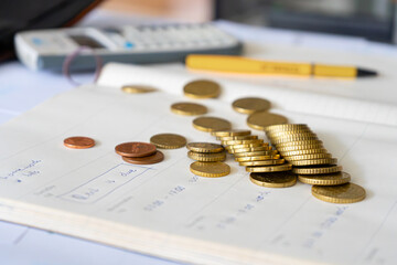 Girl and man with financial problems. Girl doing taxes, bills and invoices on the table, calculator and coins. Little bit of money in wallet. Almost no money in her wallet, trying to pay her bills.