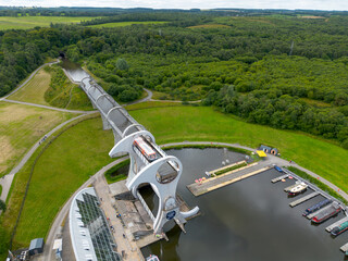 Aerial drone photo of the rotating Falkirk wheel transporting lifting narrow boats in the Forth and Clyde canal with engineering master piece in Scottish highlands
