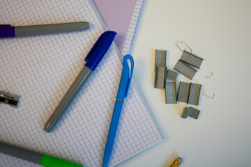 scribbled notebooks and pens with colored felt-tip pens and a stapler for studying at school 