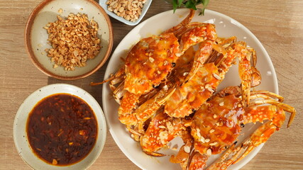 Vietnamese Tamarind Crab - Stir-Fried Crab with Tamarind Sauce and Roasted Peanuts on a White Plate
