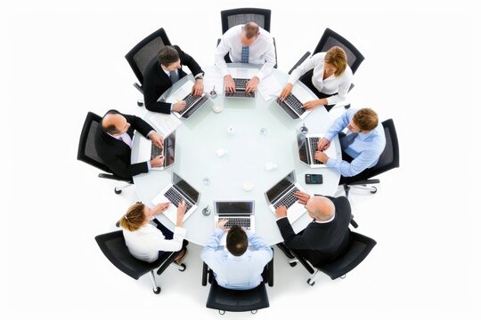 Business professionals meeting around table with laptops