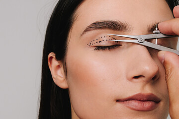 Upper blepharoplasty. Plastic surgeon is measuring surgical distance within eye of his patient...