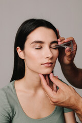Blepharoplasty marking up. Plastic surgeon is measuring distance in between marking lines for well...