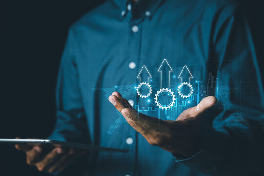 Process to increase productivity concept. Businessman holding productivity icon on virtual screen for efficient industrial management and efficient processes, for business growth