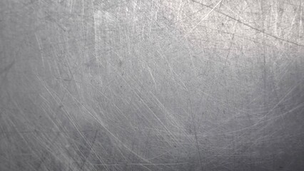 The steel plate surface has scratches from use.