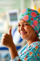 Smiling Female Cancer Patient in Hospital Gown Giving Thumbs Up
