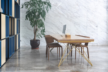 computer on wooden table and chairs in room