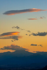 Obraz premium Sunset Clouds over Mountain Silhouettes