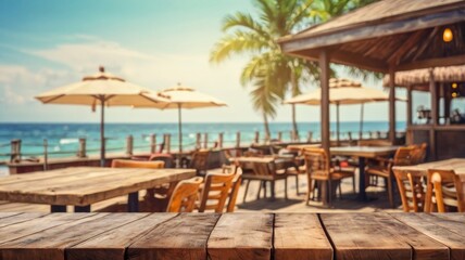 Empty wooden tabletop with blurred tropical beachfront restaurant background