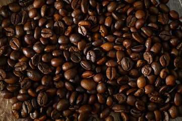 Roasted coffee beans on a flat background.