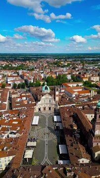 Ducale square in Vigevano, Italy Aerial view of renaissance monumental central square, shot in spring bright light against the background of a blue sky with clouds