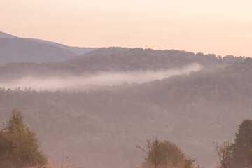 A Serene and Beautiful Landscape Featuring Majestic Mountains and a Misty Horizon Above