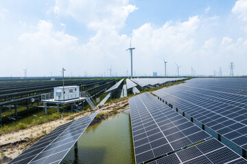 solar power station and wind power turbine over water