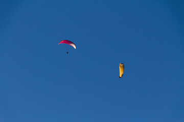 Paraplan and deltaplan in alps over a ski resort
