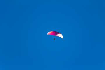Paraplan and deltaplan in alps over a ski resort
