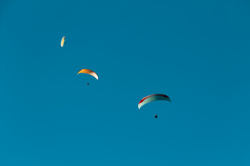 Paraplan and deltaplan in alps over a ski resort