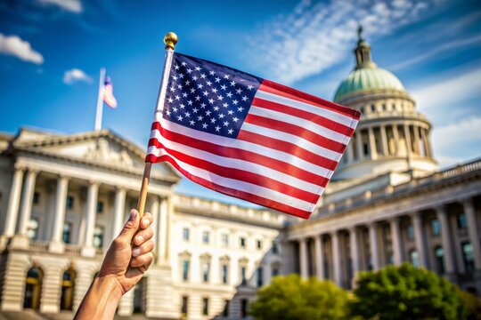American flag proudly held by hand, symbolizing national pride and patriotism, with blurred background of government