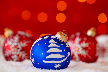 christmas colorful balls over the snow with a red background