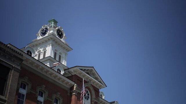 Camera pans up from street to top of Athens County Common Pleas Courthouse in the small midwest town of Athens, Ohio.