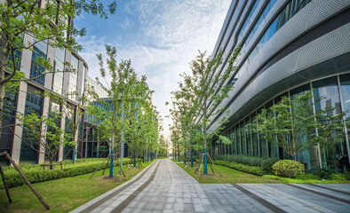 Lush Green Pathway Between Office Buildings