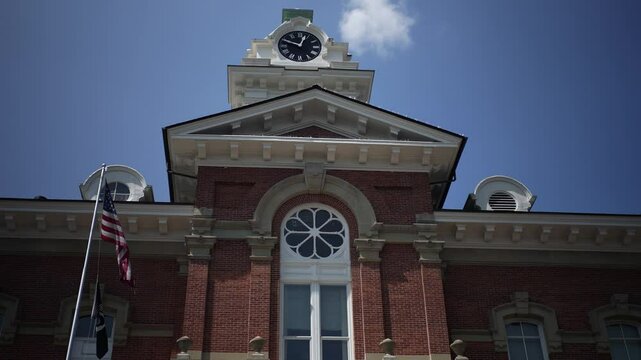 Looking up to top of Athens County Common Pleas Courthouse in the small midwest town of Athens, Ohio with clear blue sky.