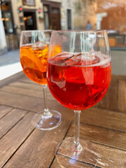 glass of Aperol Spritz & Campari Club Soda on a table in Venice, Italy