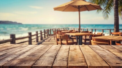 Fototapeta premium Empty wooden tabletop overlooking a beachfront restaurant with a view of the ocean