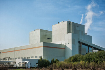 Power Station Cooling Towers Emitting Steam into Clear Sky