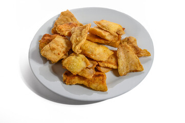 fillet of fish in batter on white plate closeup isolated on white background.