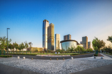 Fototapeta premium Sunrise Over Modern Urban Skyline with Landmark Buildings